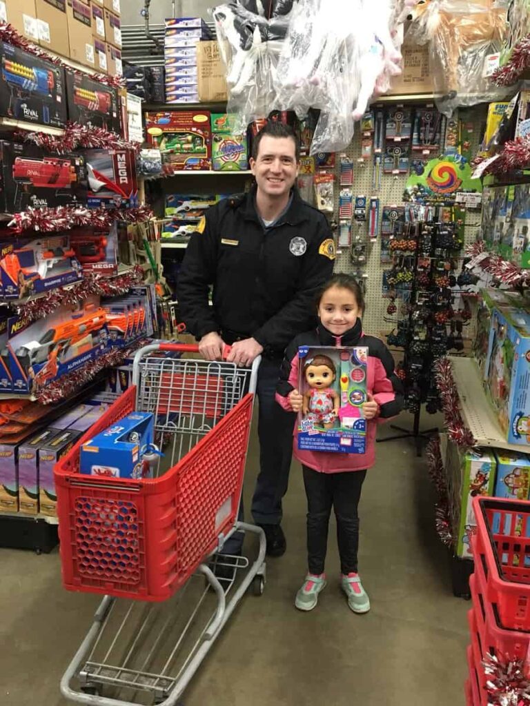 Young girl on shopping trip with Washington State Trooper in Shop with a Cop program