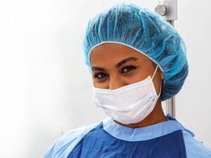 woman wearing surgical mask and protective covering